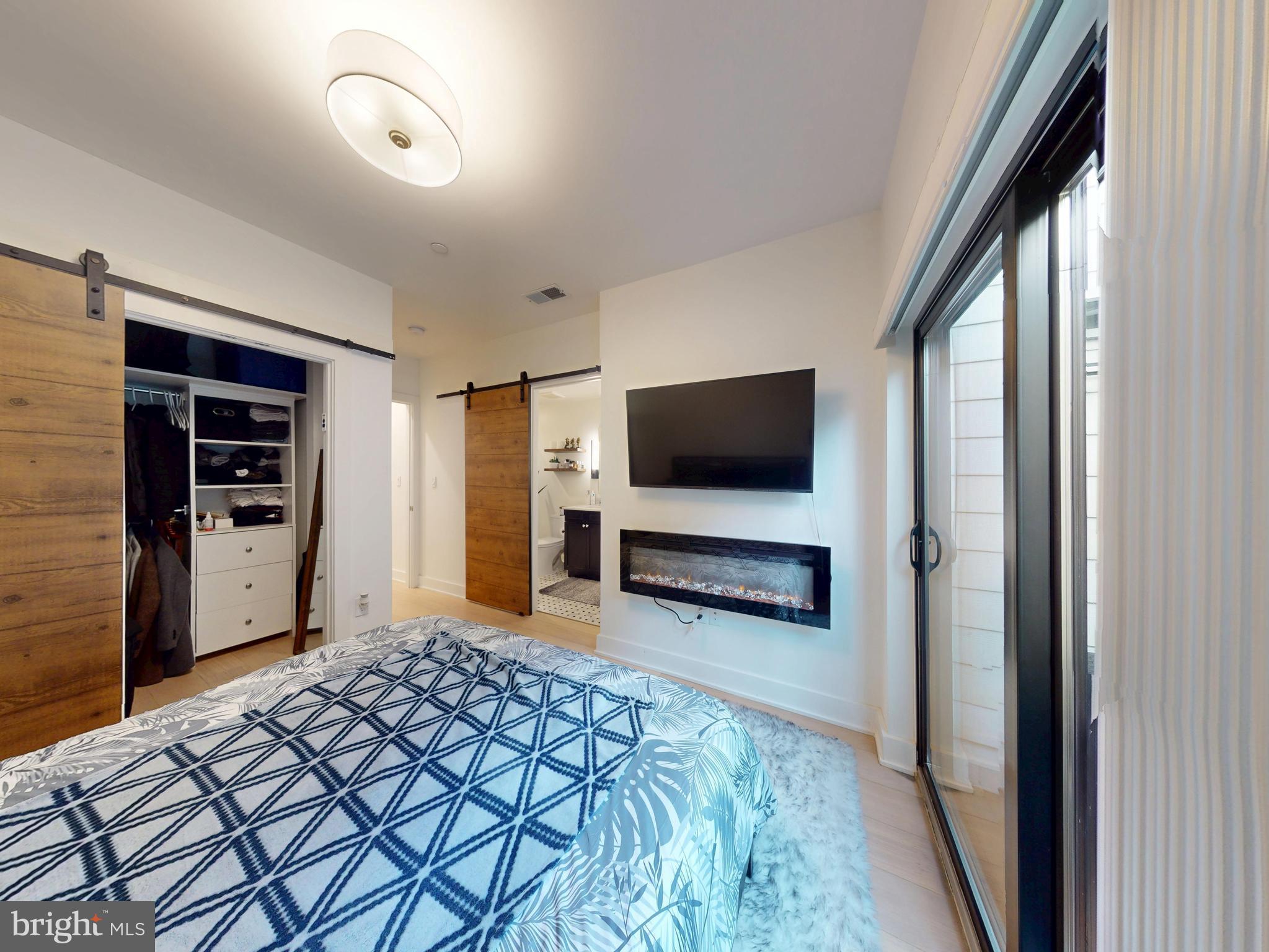 2642 39th Street Northwest, Unit 2 Washington, DC 20007 - Photo 11 of 25 a bedroom with furniture and flat screen tv