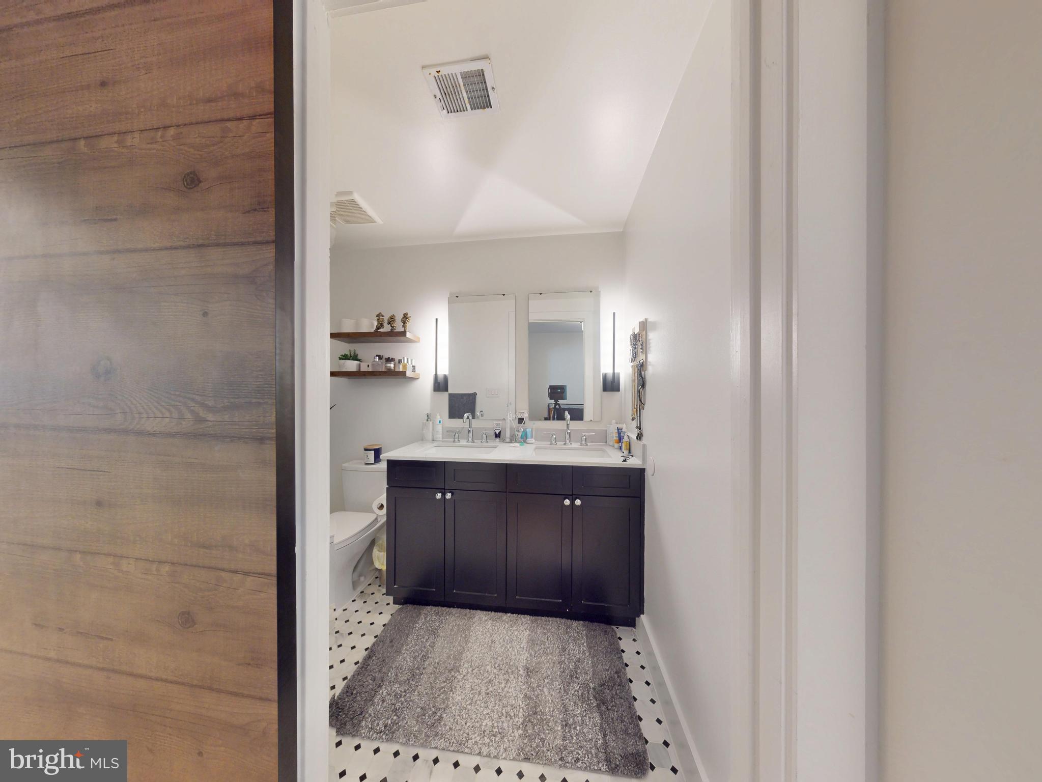2642 39th Street Northwest, Unit 2 Washington, DC 20007 - Photo 12 of 25 a bathroom with a sink and a mirror