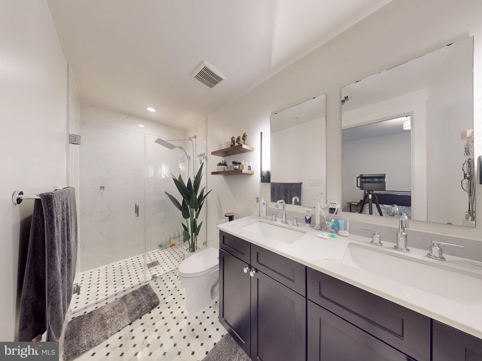 2642 39th Street Northwest, Unit 2 Washington, DC 20007 - Photo 13 of 25 a bathroom with a sink a toilet and shower