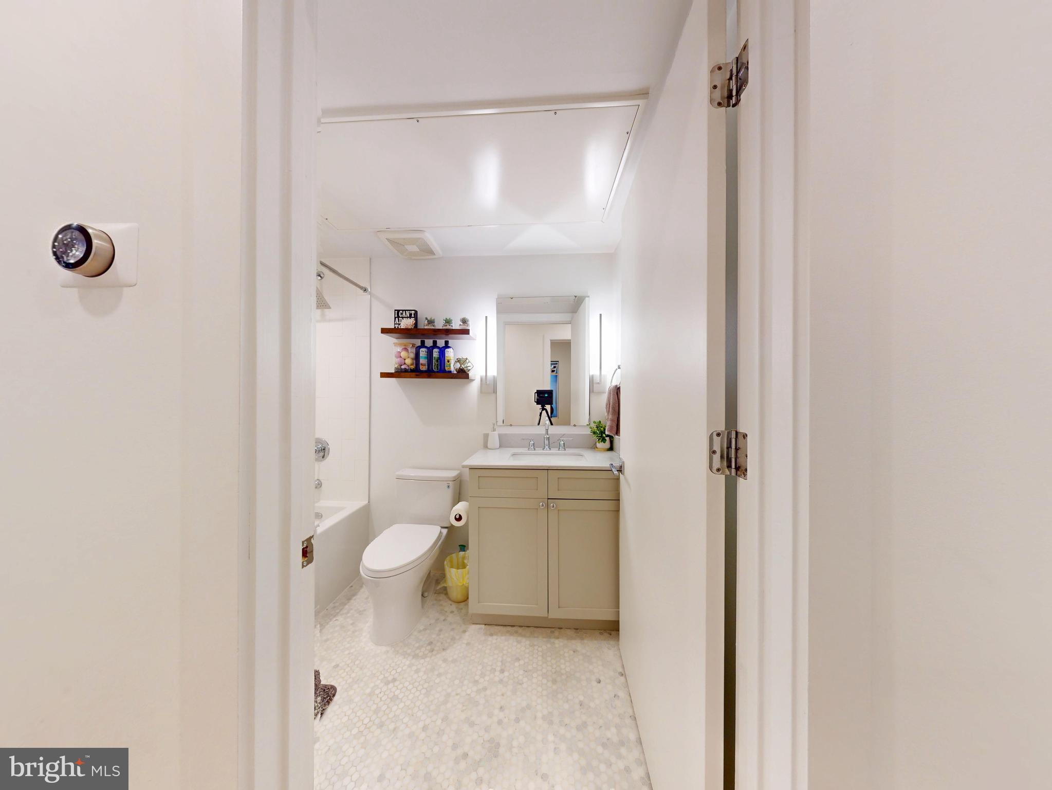 2642 39th Street Northwest, Unit 2 Washington, DC 20007 - Photo 14 of 25 a bathroom with a granite countertop sink mirror vanity and toilet