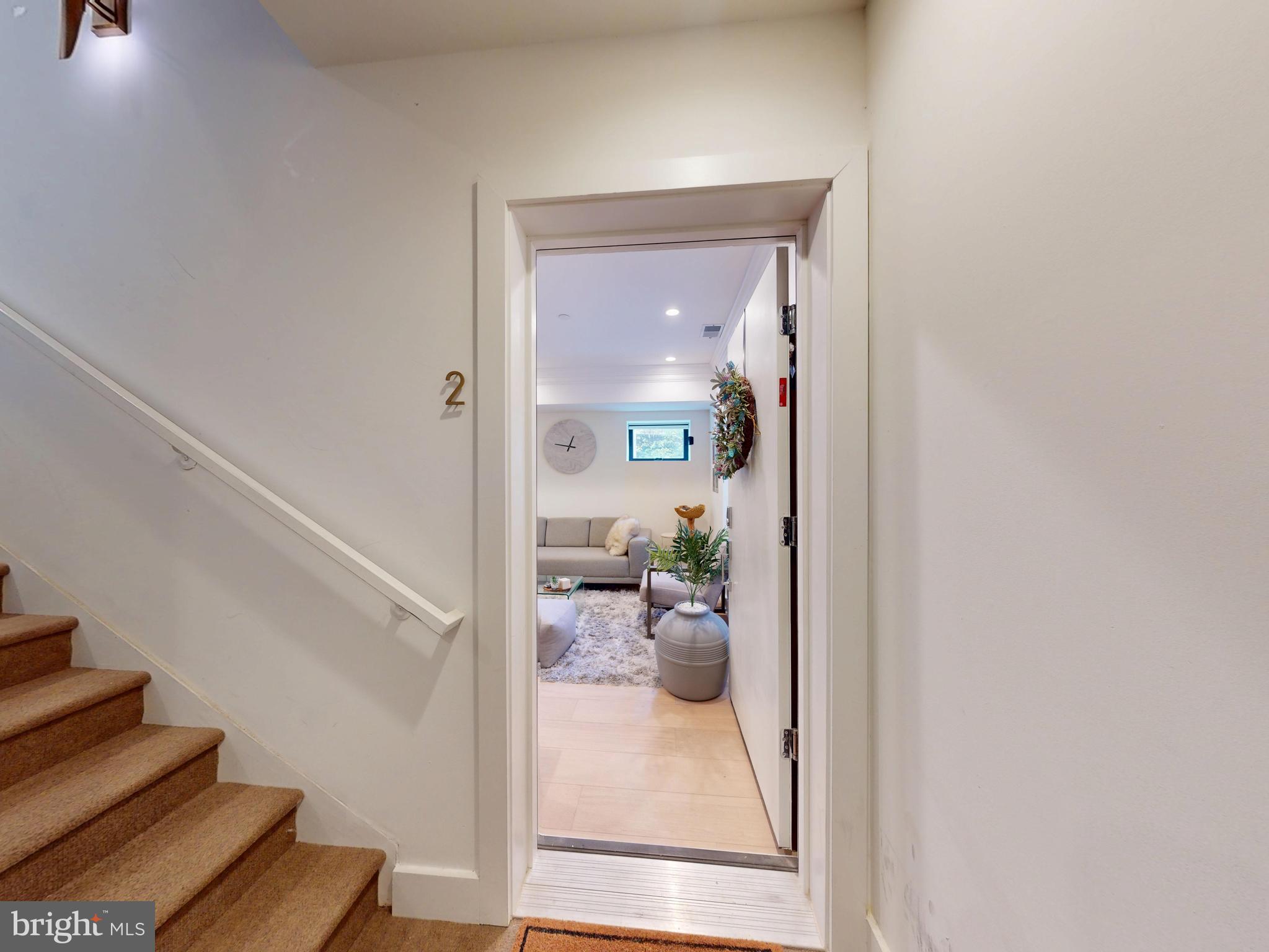 2642 39th Street Northwest, Unit 2 Washington, DC 20007 - Photo 21 of 25 a view of a hallway with living room and furniture