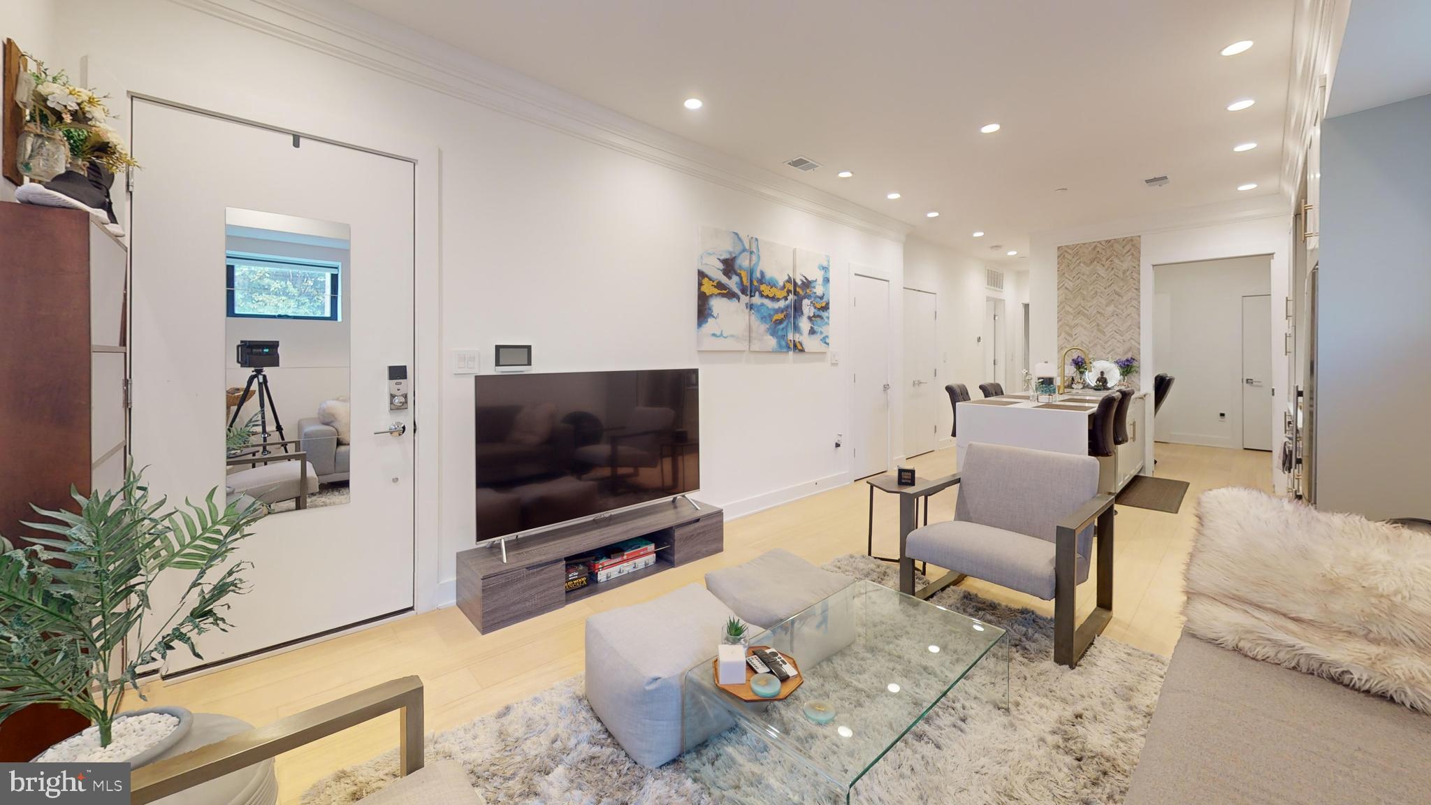 2642 39th Street Northwest, Unit 2 Washington, DC 20007 - Photo 4 of 25 a living room with furniture and a flat screen tv