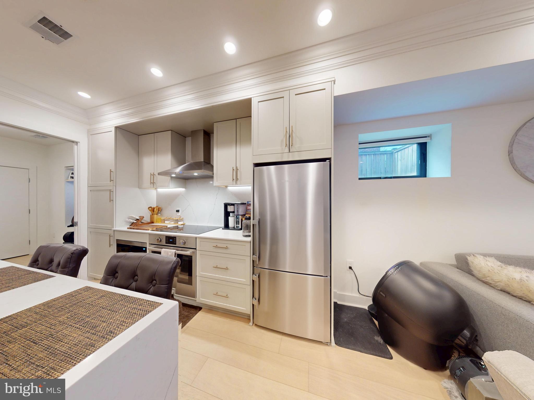 2642 39th Street Northwest, Unit 2 Washington, DC 20007 - Photo 6 of 25 a kitchen with stainless steel appliances granite countertop a refrigerator sink and stove