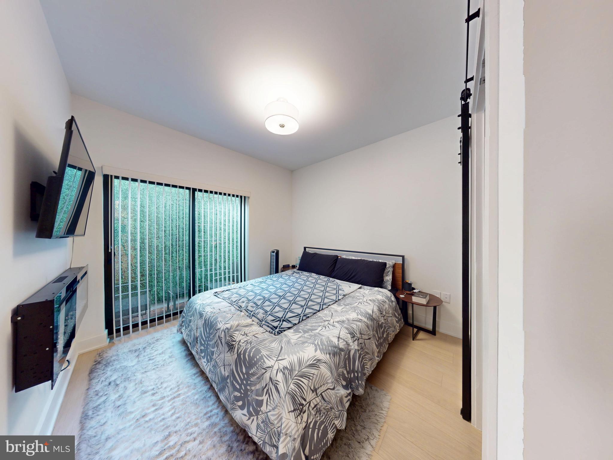 2642 39th Street Northwest, Unit 2 Washington, DC 20007 - Photo 10 of 25 a bedroom with a bed and a television