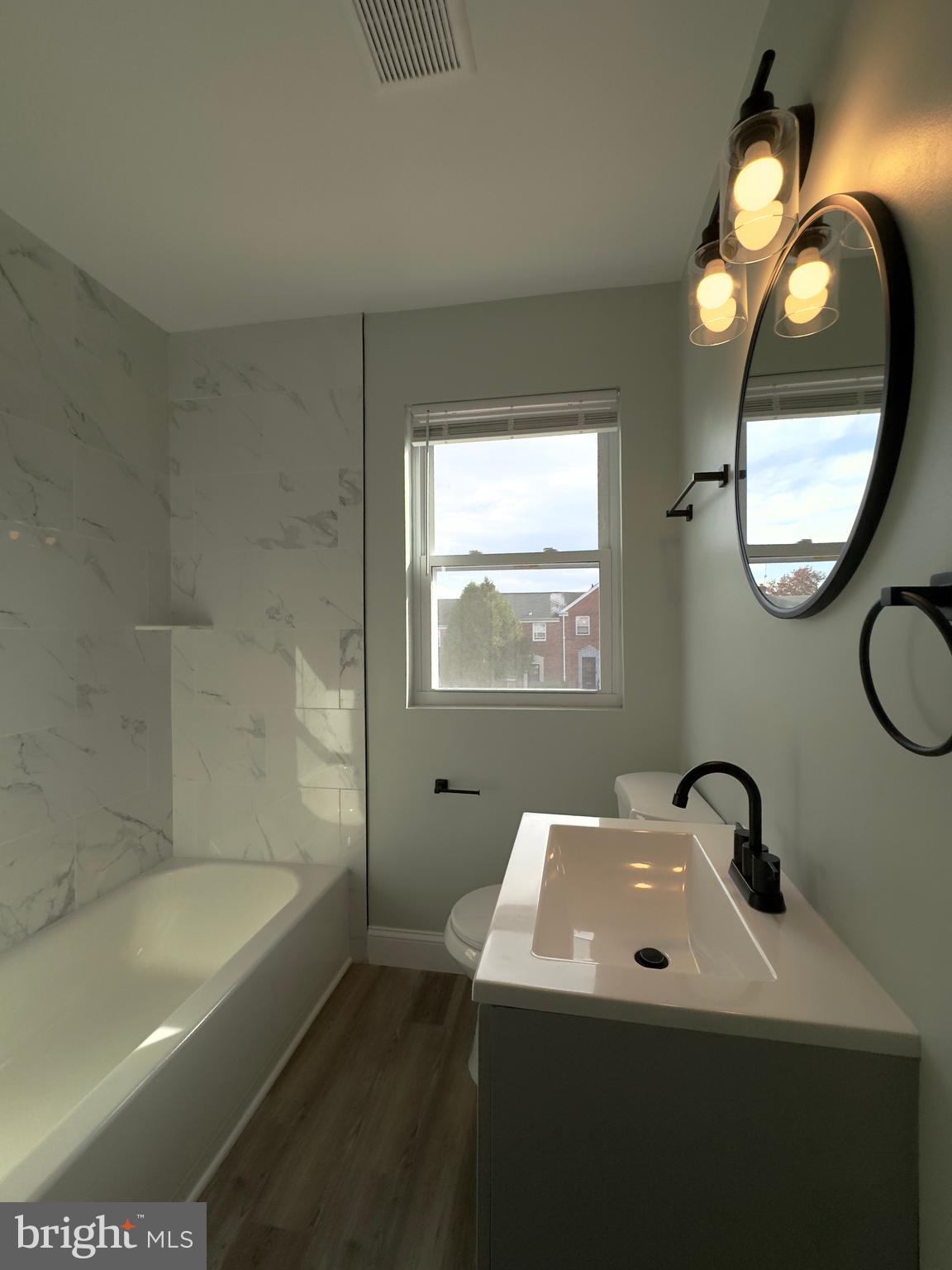 5430 Whitlock Road Baltimore, MD 21229 - Photo 17 of 30 a bathroom with a sink a toilet and a bathtub