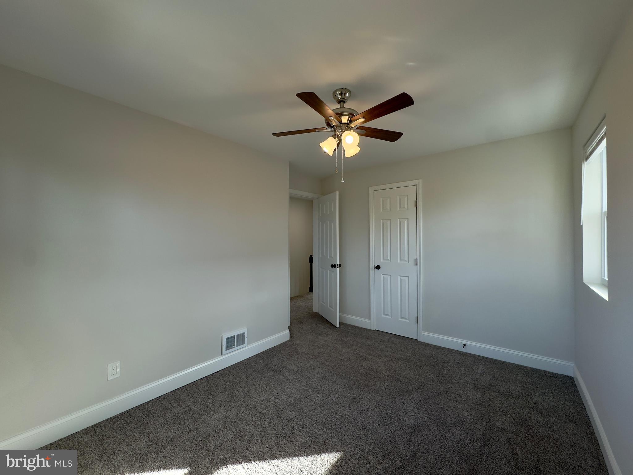 5430 Whitlock Road Baltimore, MD 21229 - Photo 30 of 30 an empty room with a window and a fan