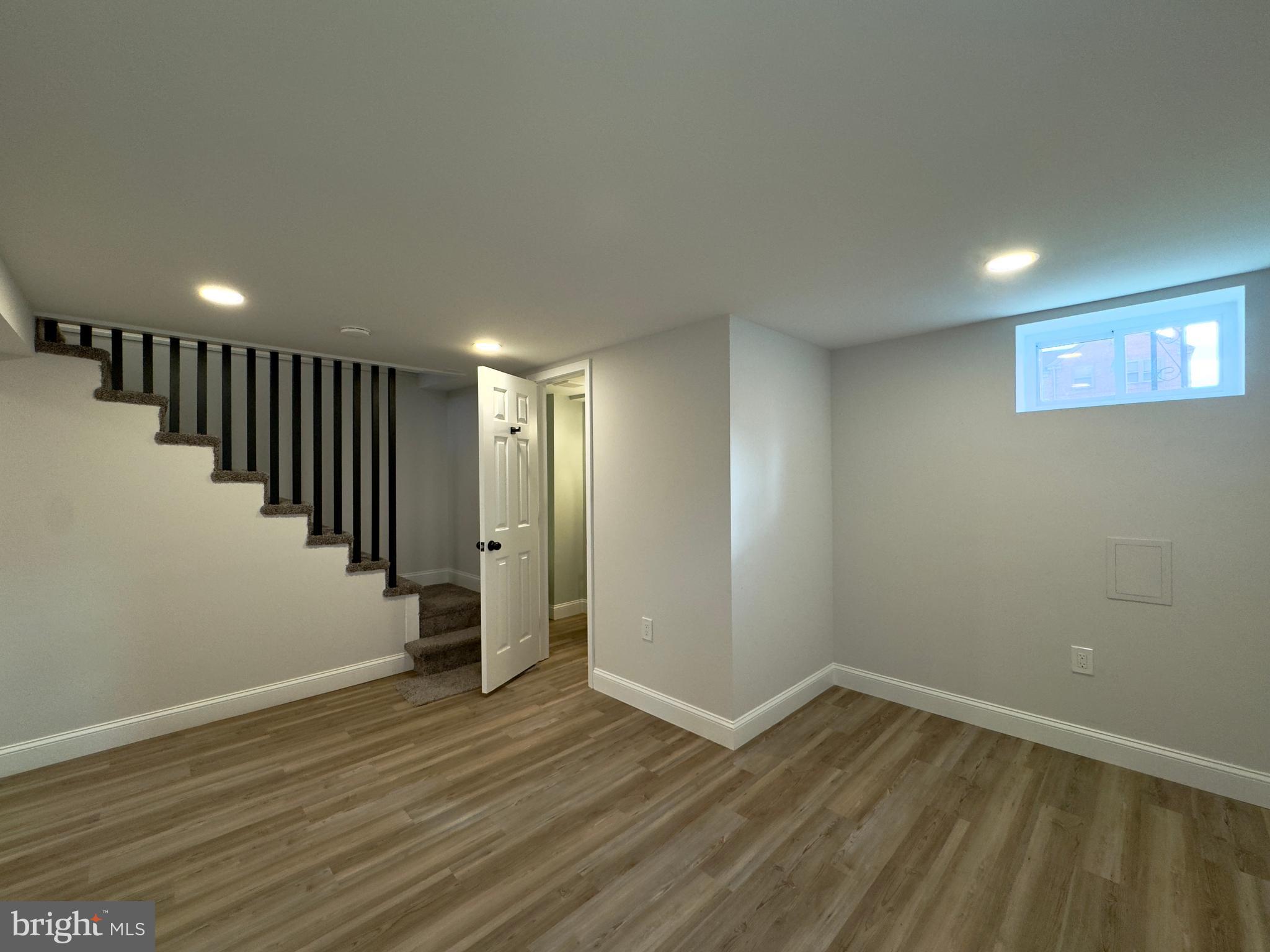 5430 Whitlock Road Baltimore, MD 21229 - Photo 8 of 30 a view of an empty room with wooden floor