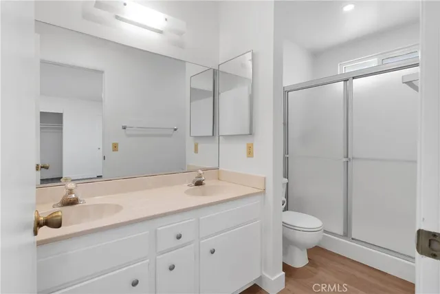 a bathroom with a sink a toilet and a large mirror