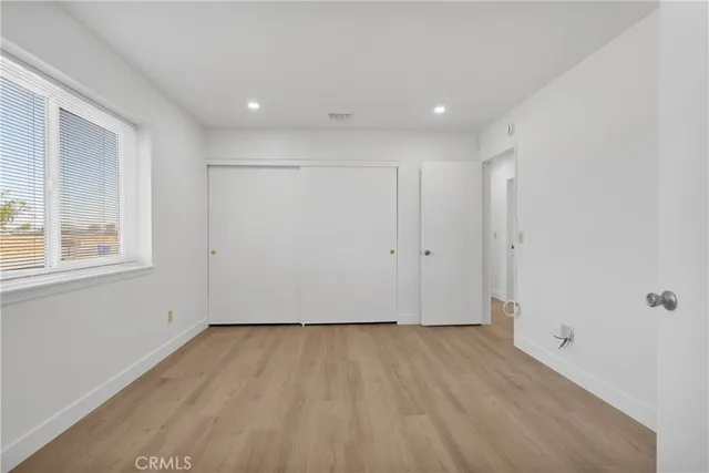 a view of room with window and wooden floor