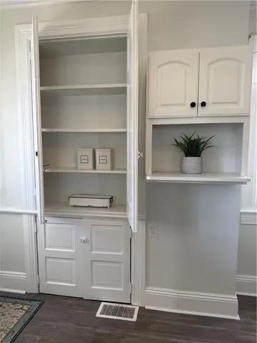 a view of cabinets and wooden floor