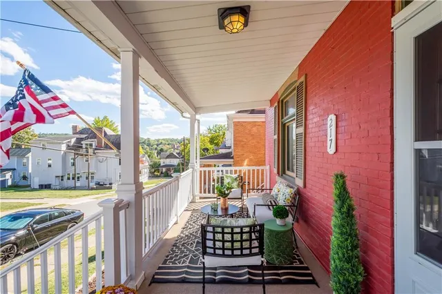 a view of a balcony with furniture and floor to ceiling window
