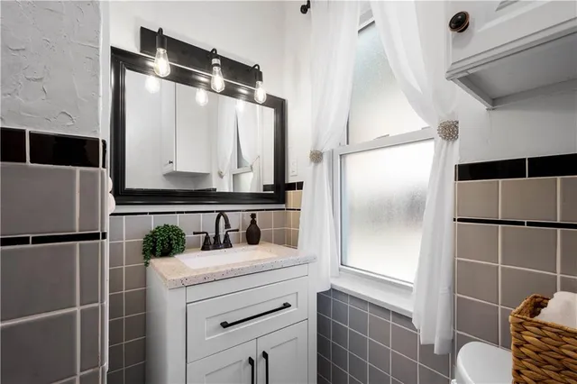 a kitchen with a refrigerator and a sink