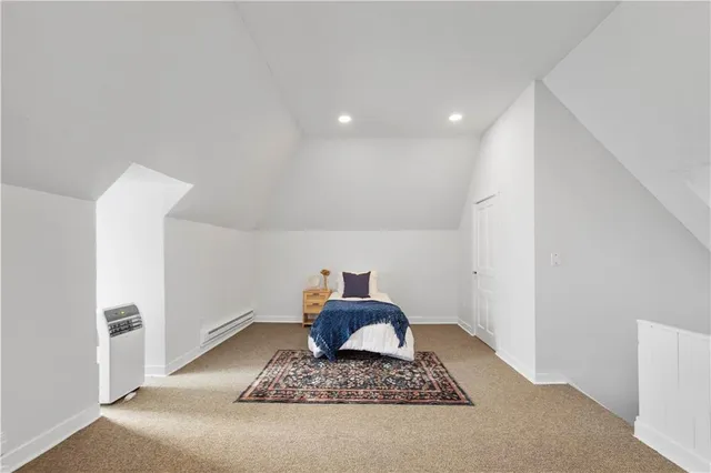 a room with a rug and a hallway