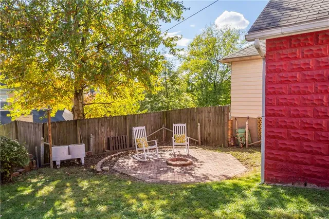 a backyard of a house with table and chairs