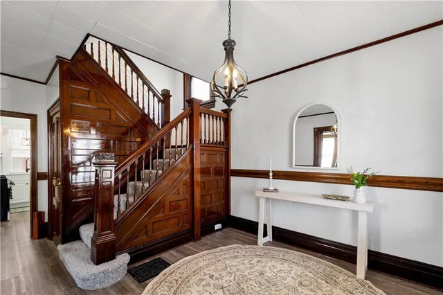 a room with stairs and wooden floor
