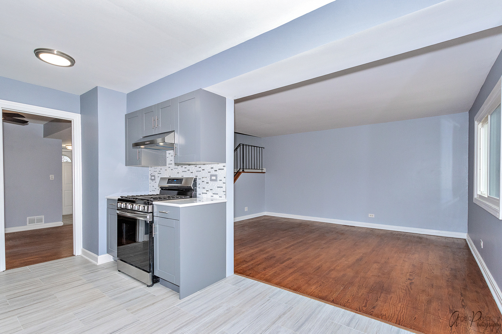 452 Maple Drive Wheeling, IL 60090 - Photo 7 of 30 a kitchen with a stove top oven and white cabinets