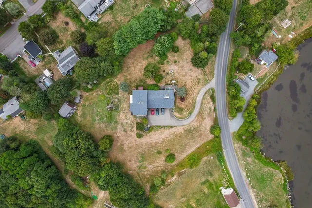 an aerial view of a house with a yard