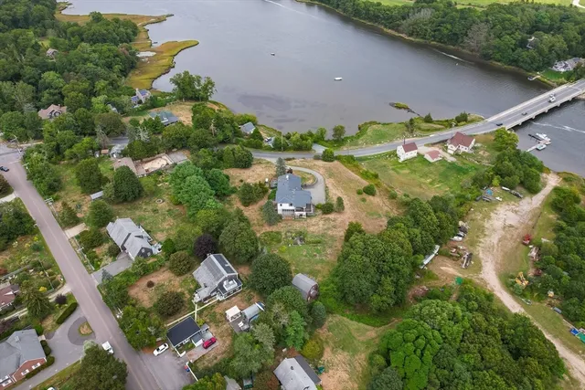 an aerial view of residential houses with outdoor space and street view