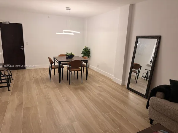 a dining room with furniture and wooden floor