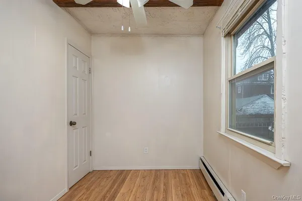 a view of room with window and hardwood floor
