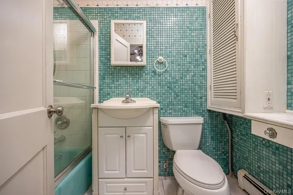 a bathroom with a toilet a sink and garden