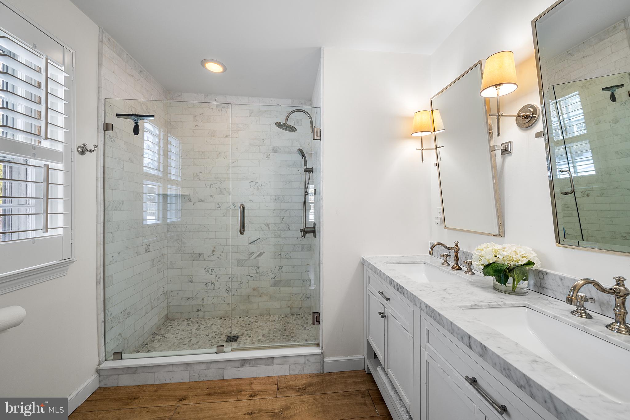 48 Northwoods Road Wayne, PA 19087 - Photo 19 of 31 a bathroom with a double vanity sink mirror and shower