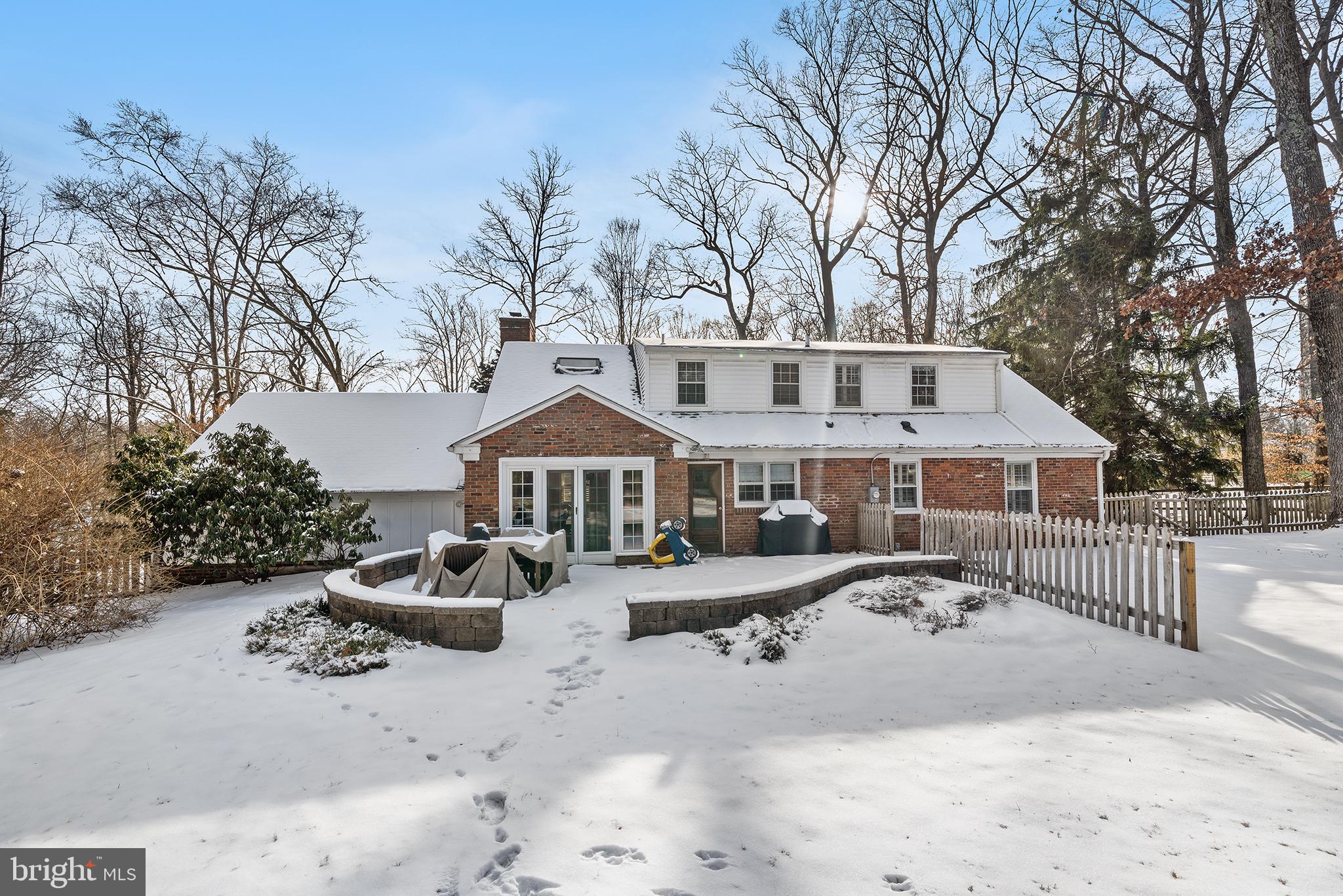 48 Northwoods Road Wayne, PA 19087 - Photo 26 of 31 a front view of a house with a yard covered with snow in front of house