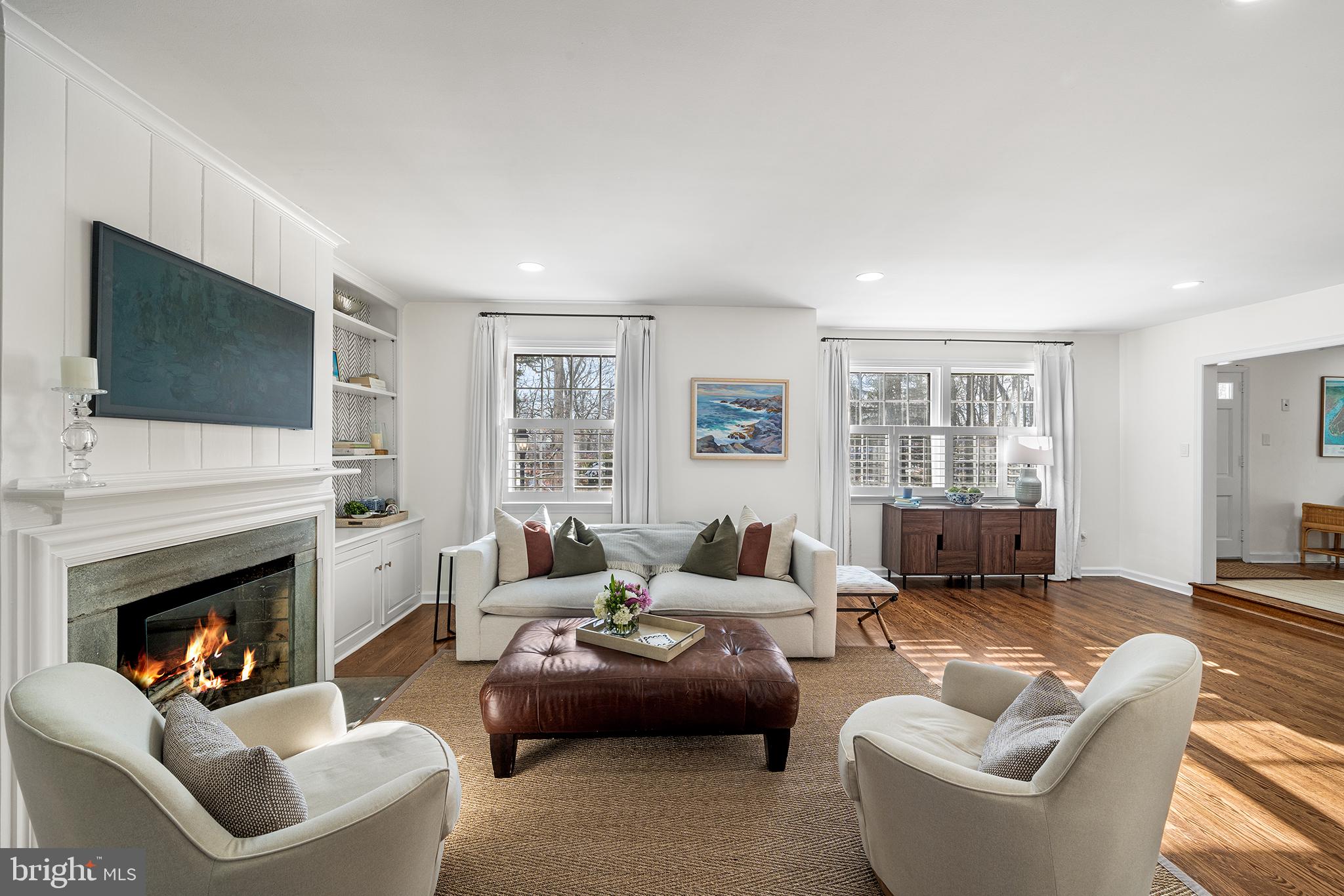 48 Northwoods Road Wayne, PA 19087 - Photo 8 of 31 a living room with furniture a fireplace and a flat screen tv