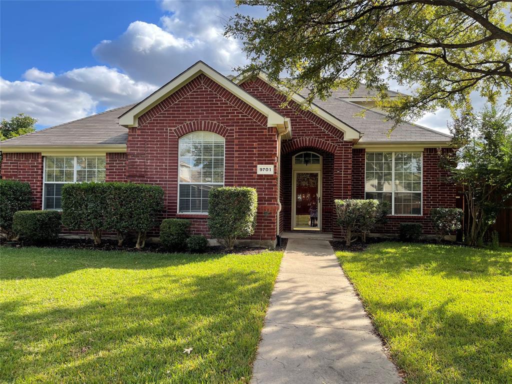 a front view of a house with yard and green space