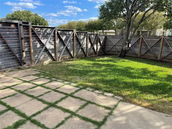 a view of a backyard with wooden fence