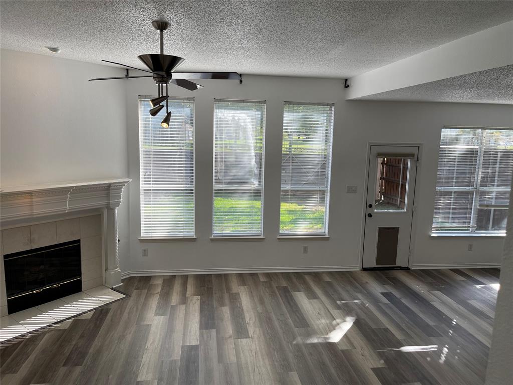9701 Spring Drive Frisco, TX 75035 - Photo 2 of 18 a view of an empty room with a fireplace and a window