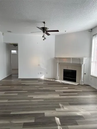 a view of empty room with a fireplace and fan