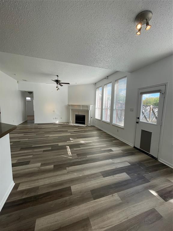 9701 Spring Drive Frisco, TX 75035 - Photo 4 of 18 a view of empty room with wooden floor and fan