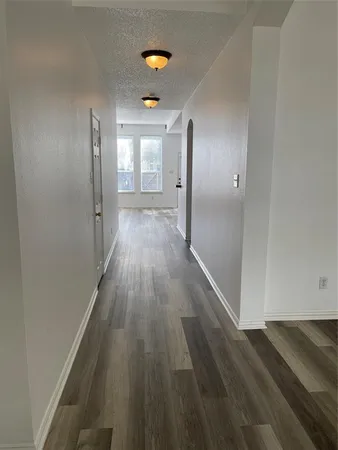 a view of hallway with wooden floor