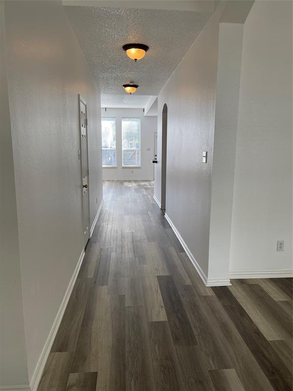 9701 Spring Drive Frisco, TX 75035 - Photo 9 of 18 a view of hallway with wooden floor