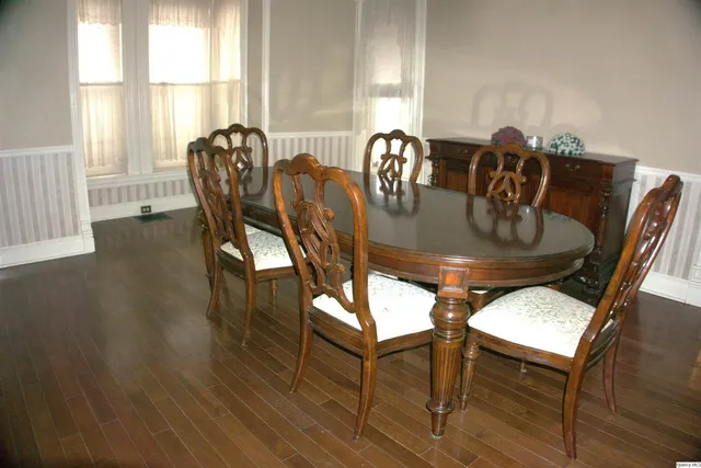 a view of a dining room with furniture and chandelier
