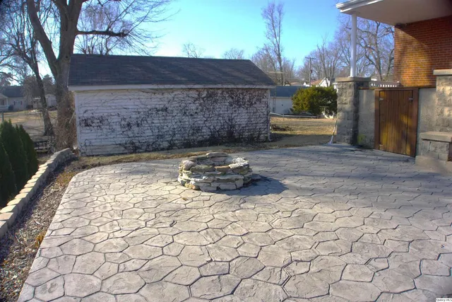 a front view of house with yard and trees around