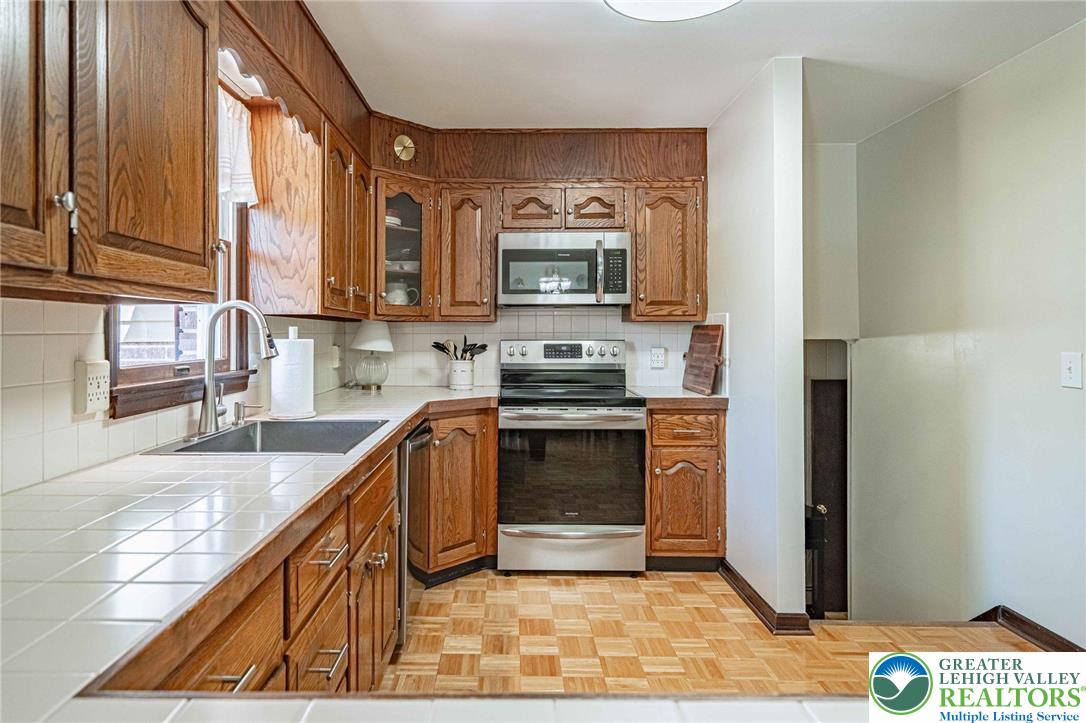 3857 Friedens Road Slatington, PA 18080 - Photo 28 of 75 This spacious kitchen offers ample storage and a functional layout for culinary endeavors.