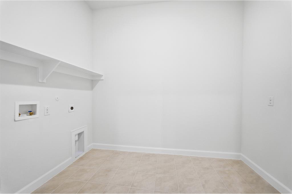 2020 Casting Ridge Mesquite, TX 75181 - Photo 31 of 34 Utility room with neutral tile flooring and white baseboards
