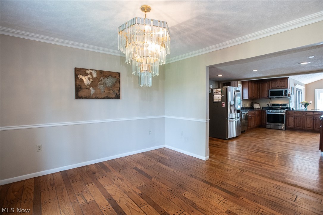 7075 Valley View Road Hudson, OH 44236 - Photo 8 of 17 Formal dining room with hardwood floors, leading to kitchen