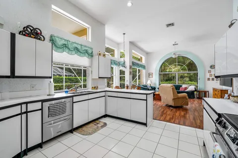 a large white kitchen with a large window