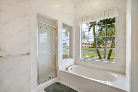 a bathroom with a bathtub and a shower