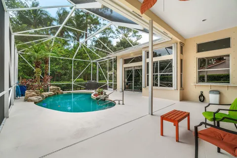 a backyard of a house with outdoor seating and a garden