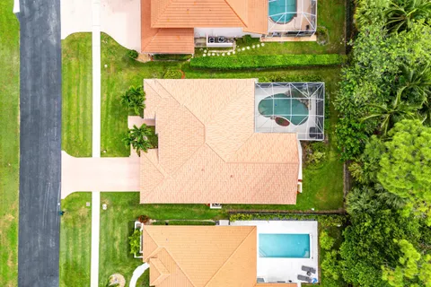 a view of a swimming pool with a patio and a yard