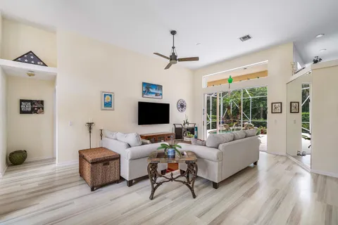 a living room with furniture flat screen tv and a wooden floor