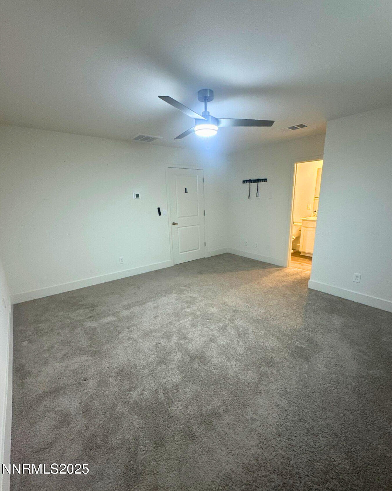 1243 Cedarhaven Court Reno, NV 89523 - Photo 11 of 20 en empty room with windows and fan
