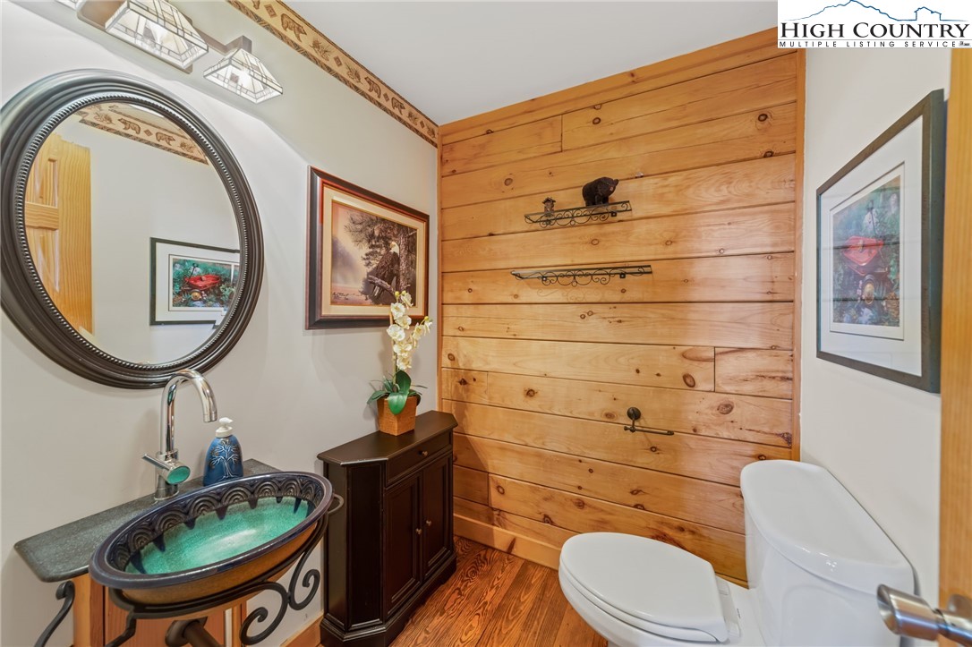196 Eagle Nest Road Purlear, NC 28665 - Photo 19 of 36 a bathroom with a toilet a sink and mirror
