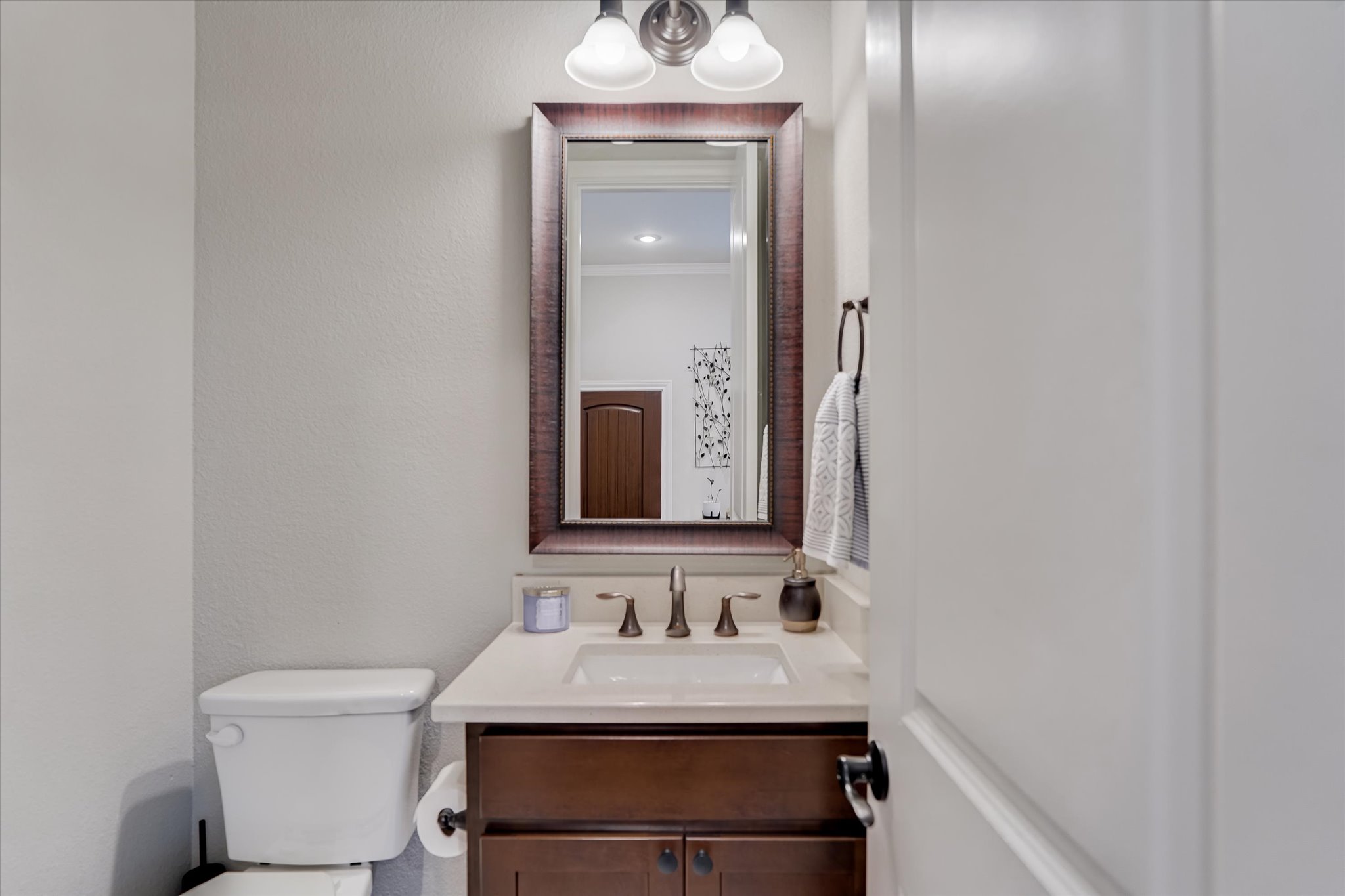 309 Adams Street Georgetown, TX 78628 - Photo 12 of 30 Bathroom featuring vanity, ornamental molding, and a textured wall