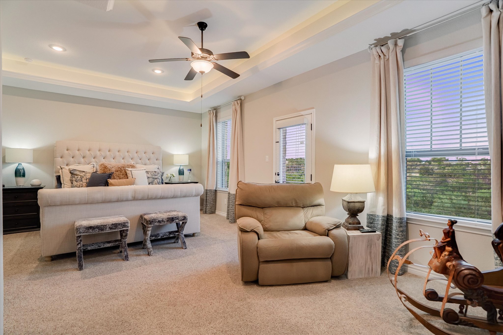 309 Adams Street Georgetown, TX 78628 - Photo 17 of 30 Bedroom with light carpet, juliet balcony, a tray ceiling, ceiling fan, and recessed lighting