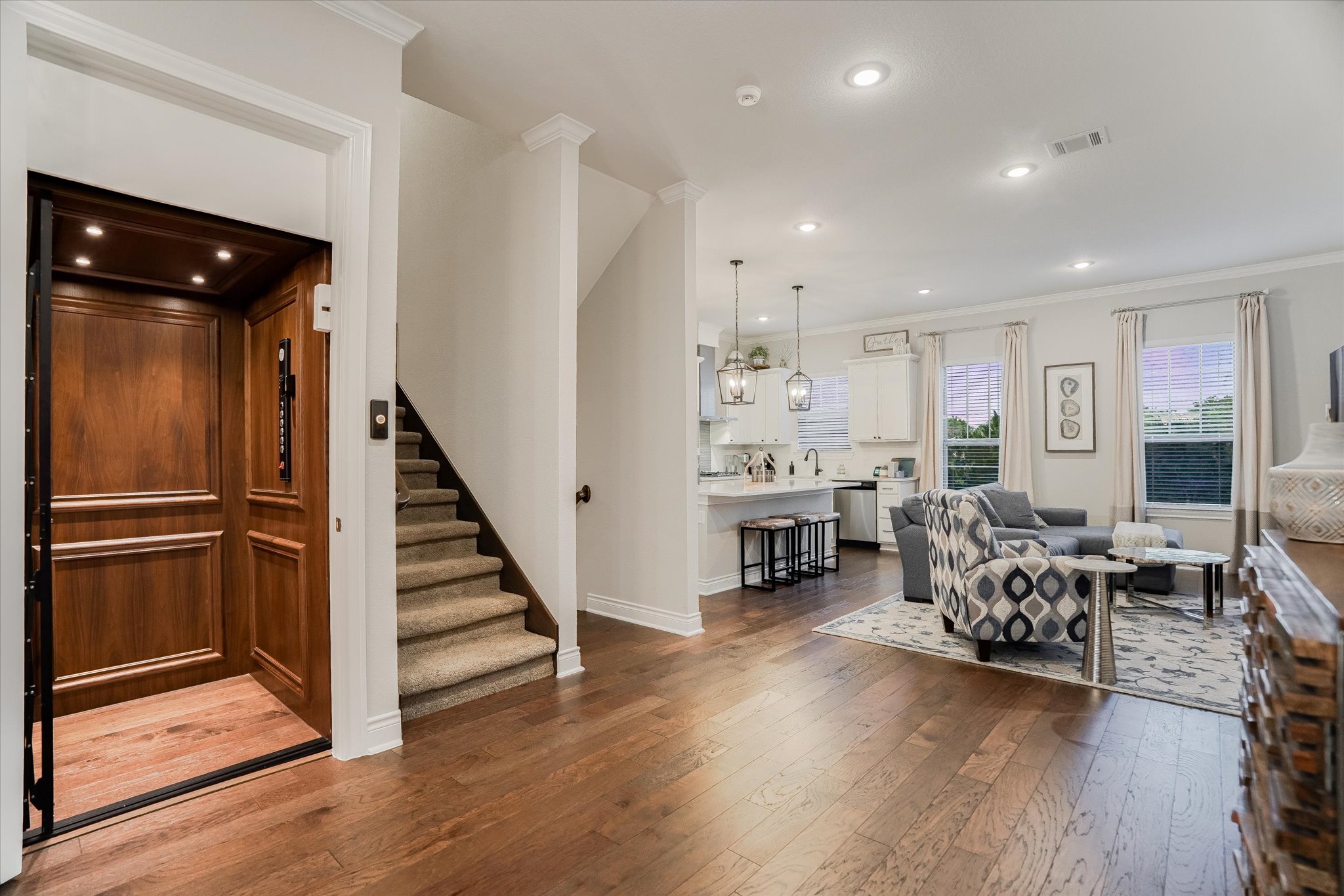 309 Adams Street Georgetown, TX 78628 - Photo 6 of 30 Living room with crown molding, dark wood-style floors, elevator, and recessed lighting